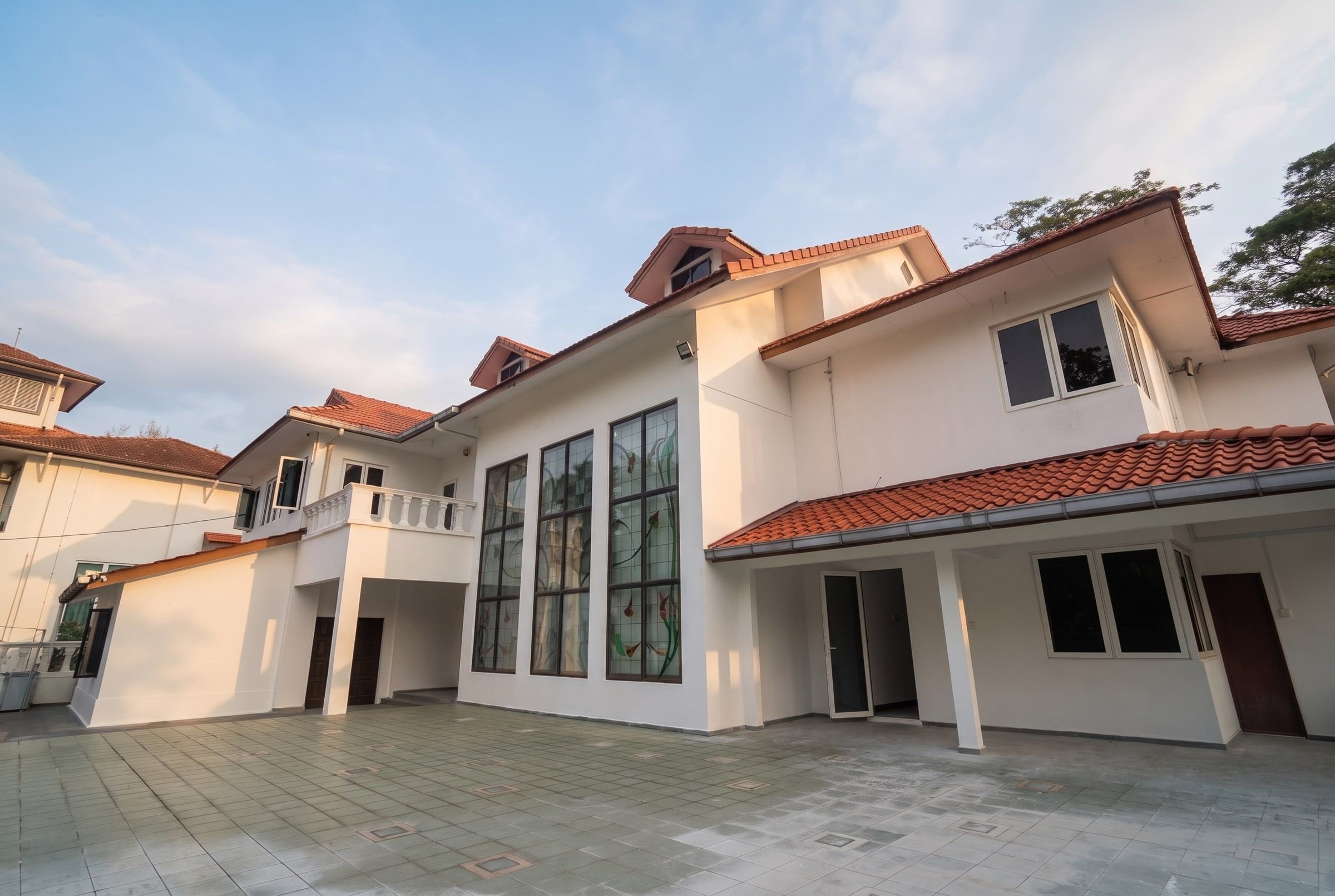 White annex wing of the residence with tall windows