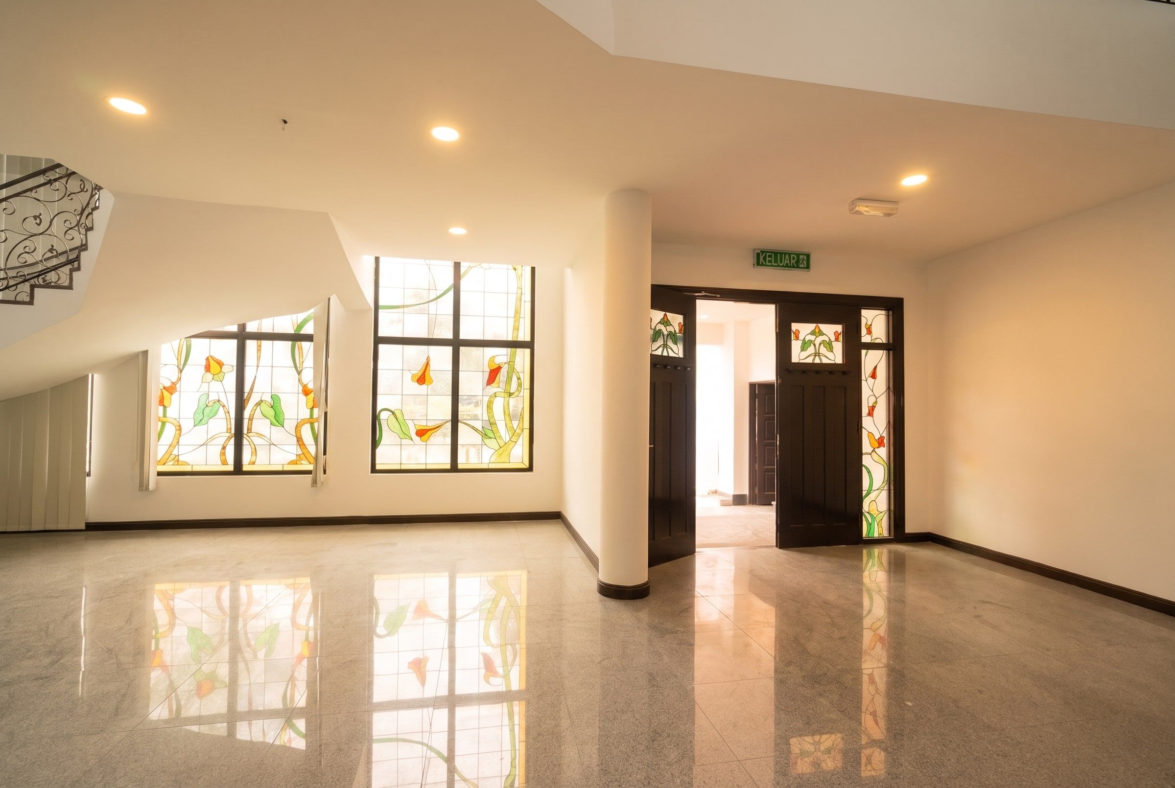 Front entrance with stained-glass panels inside the Trivelle Living foyer