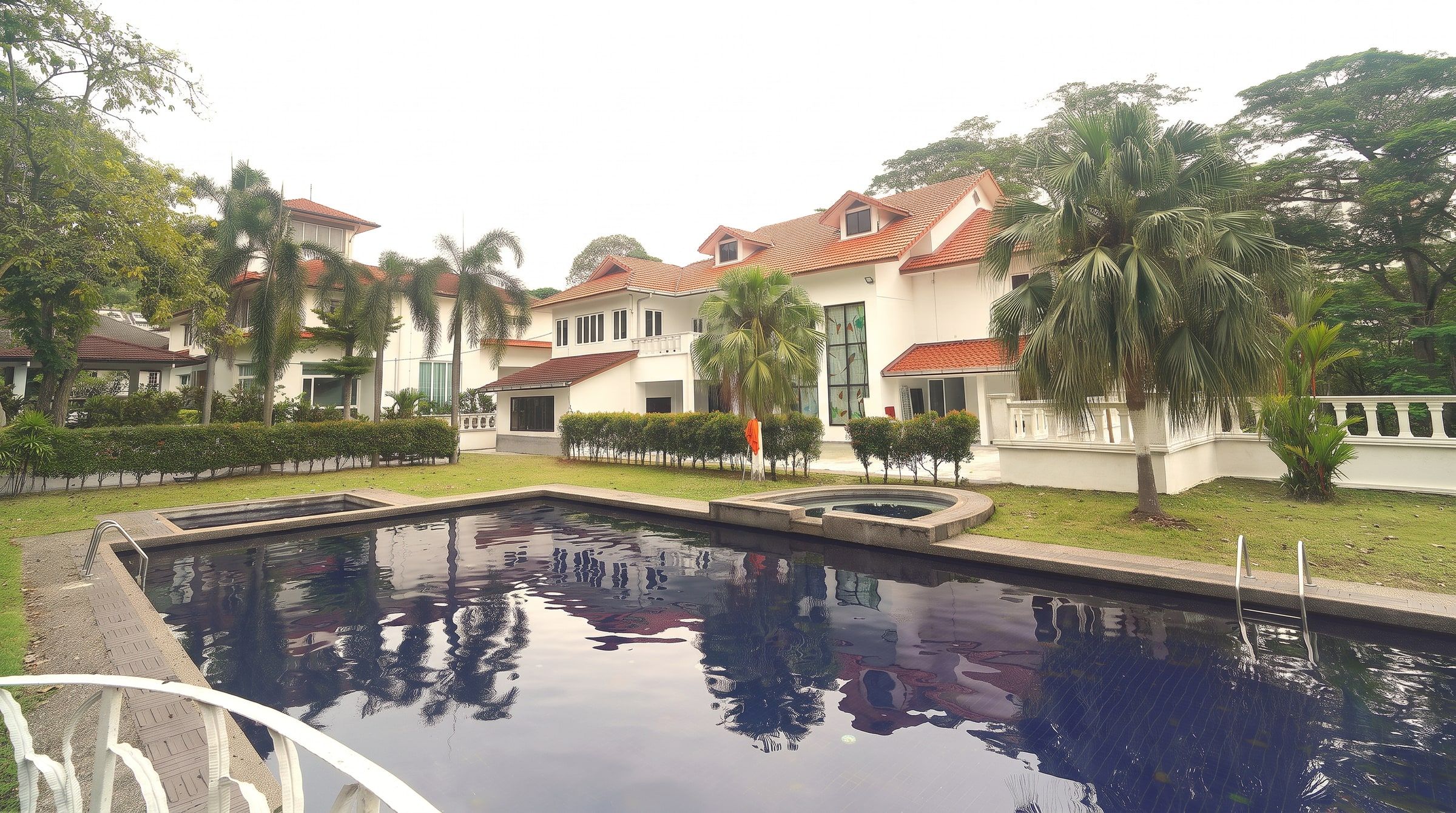 Dusk settling over the garden, pool and bungalow at Trivelle Living