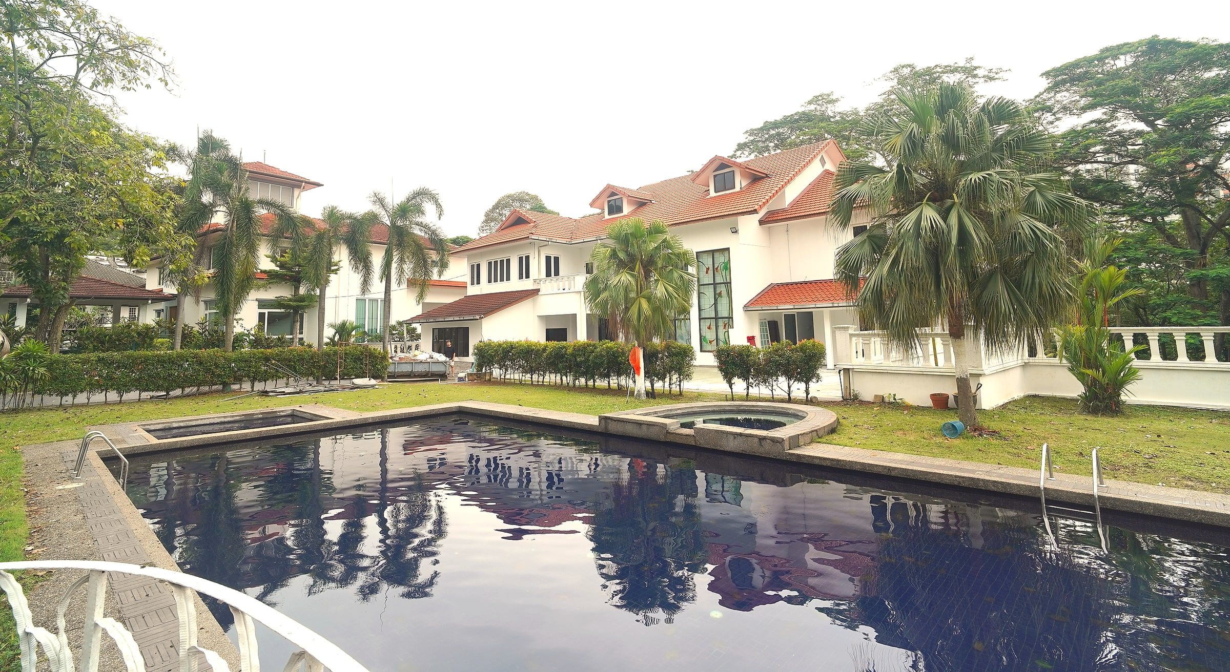 Dusk settling over the garden, pool and bungalow at Trivelle Living