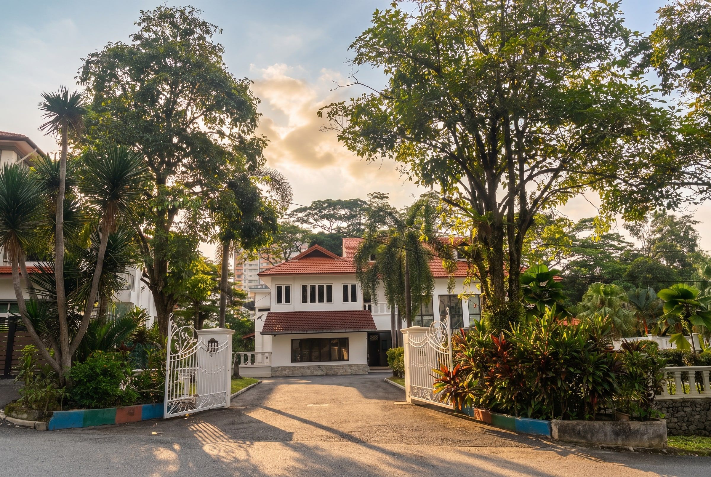 Mature trees arching over the residence's gateway
