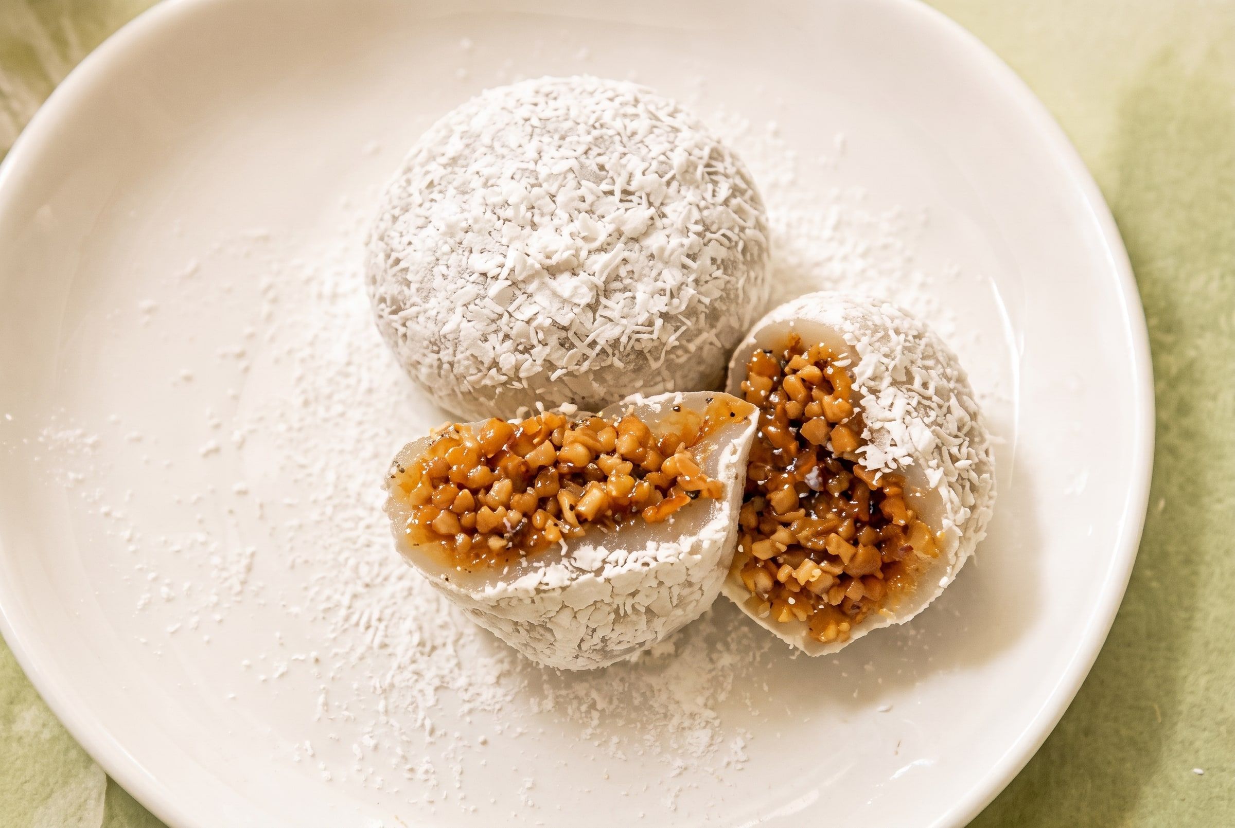 Peanut glutinous rice balls, one cut open showing the peanut filling