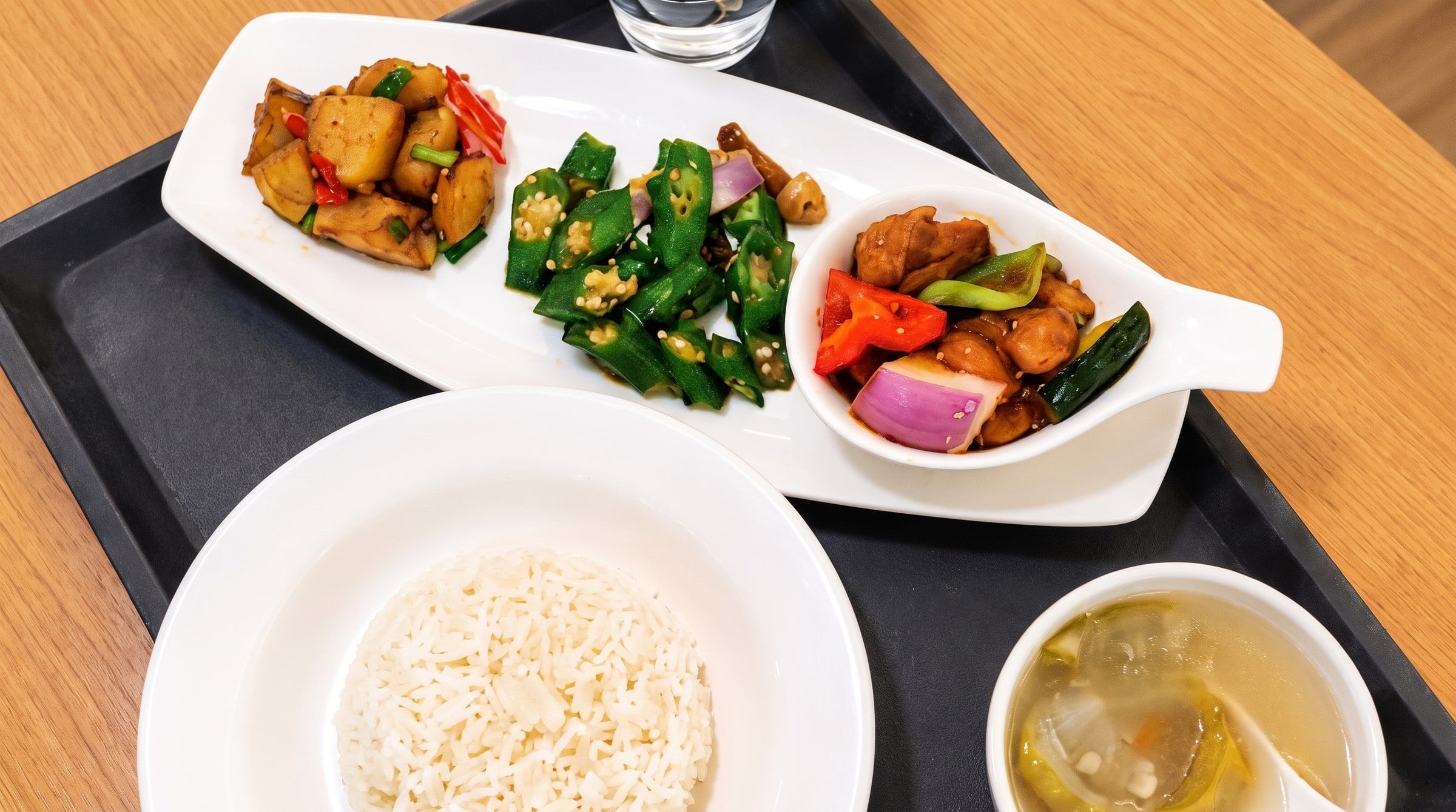 Balanced meal tray with rice, soup and dishes — cooked with less oil