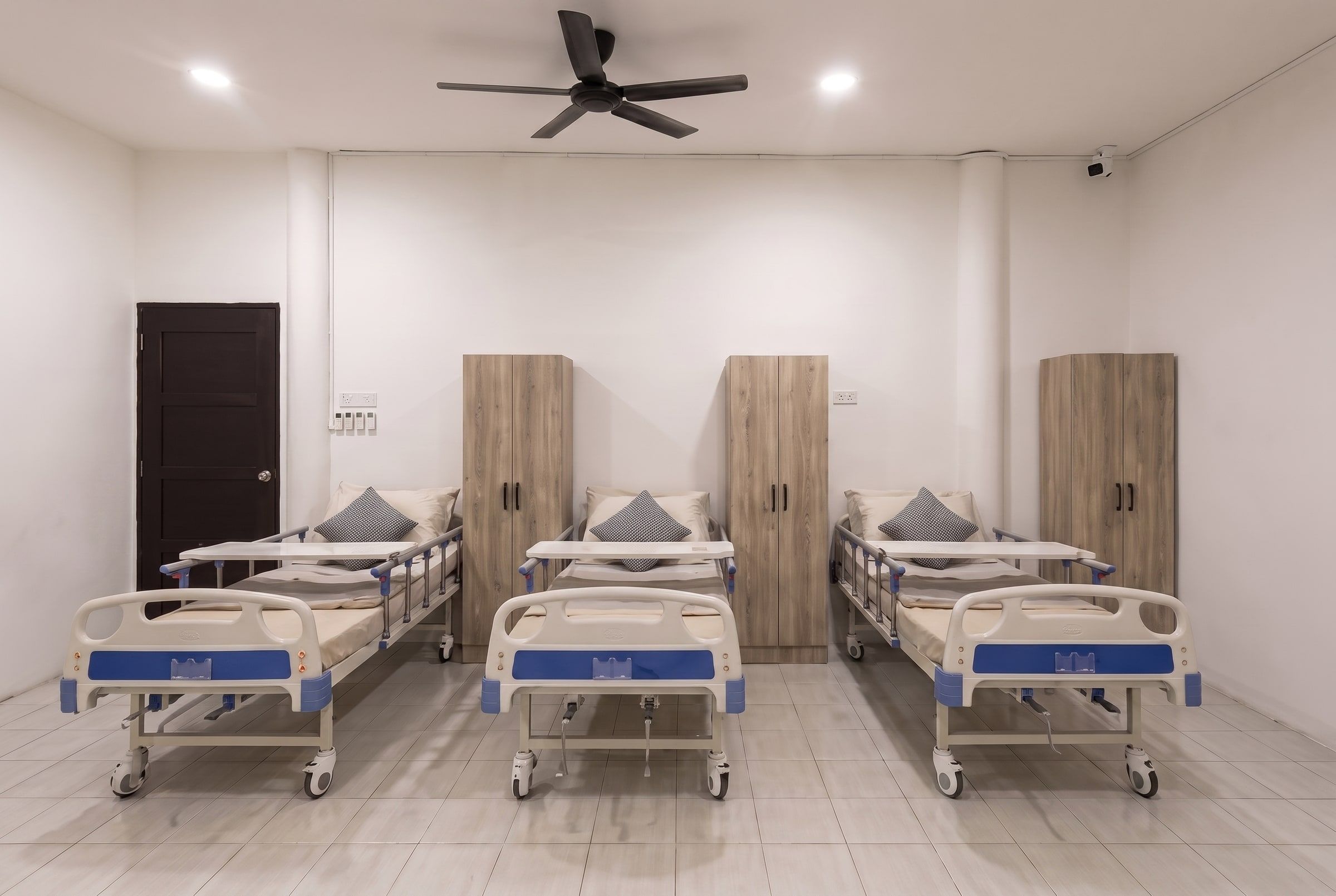 Renovated medical room with adjustable beds, safety rails and wardrobes
