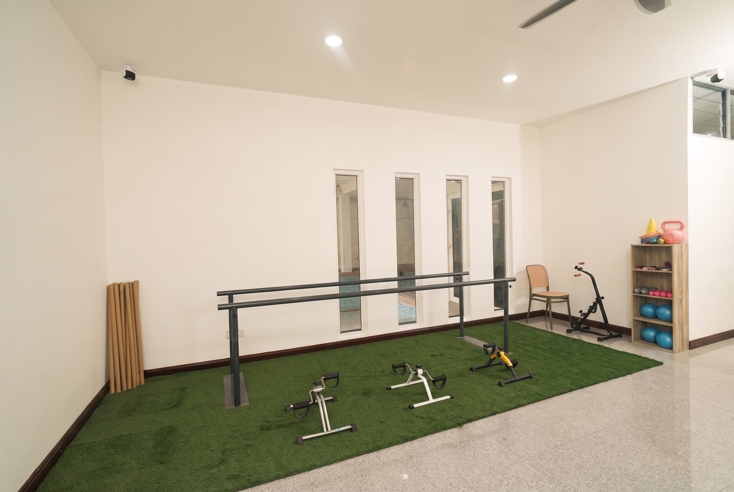Walking bars and seated exercise corner of the physio area