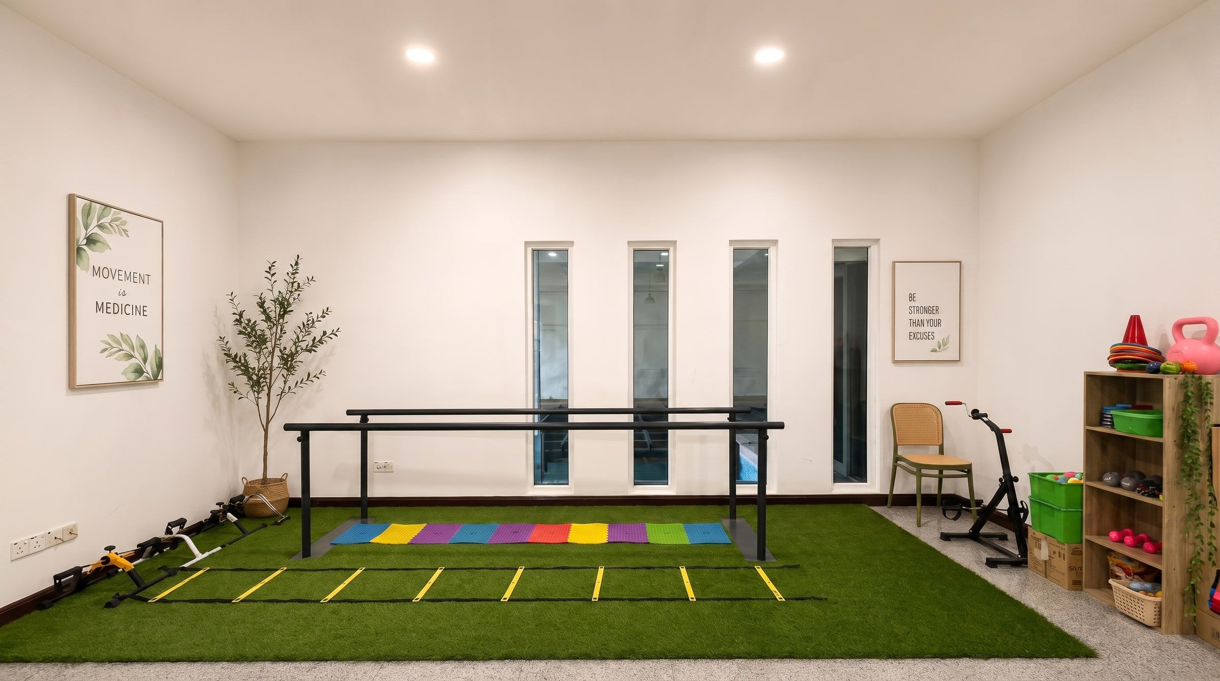 The renovated physiotherapy room with parallel bars, agility ladder and exercise turf