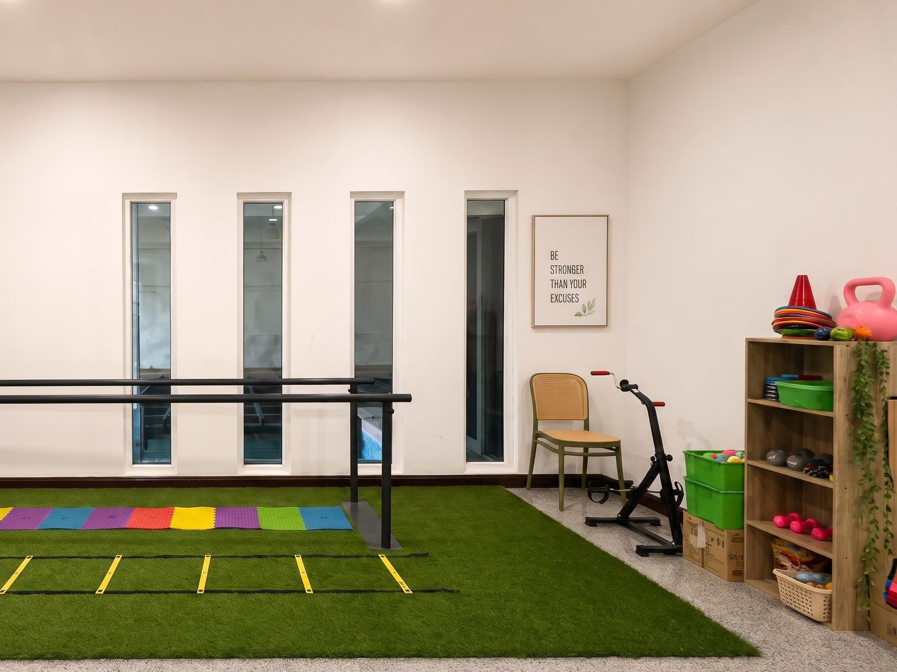 The renovated physio space — parallel bars, training corner and equipment shelf