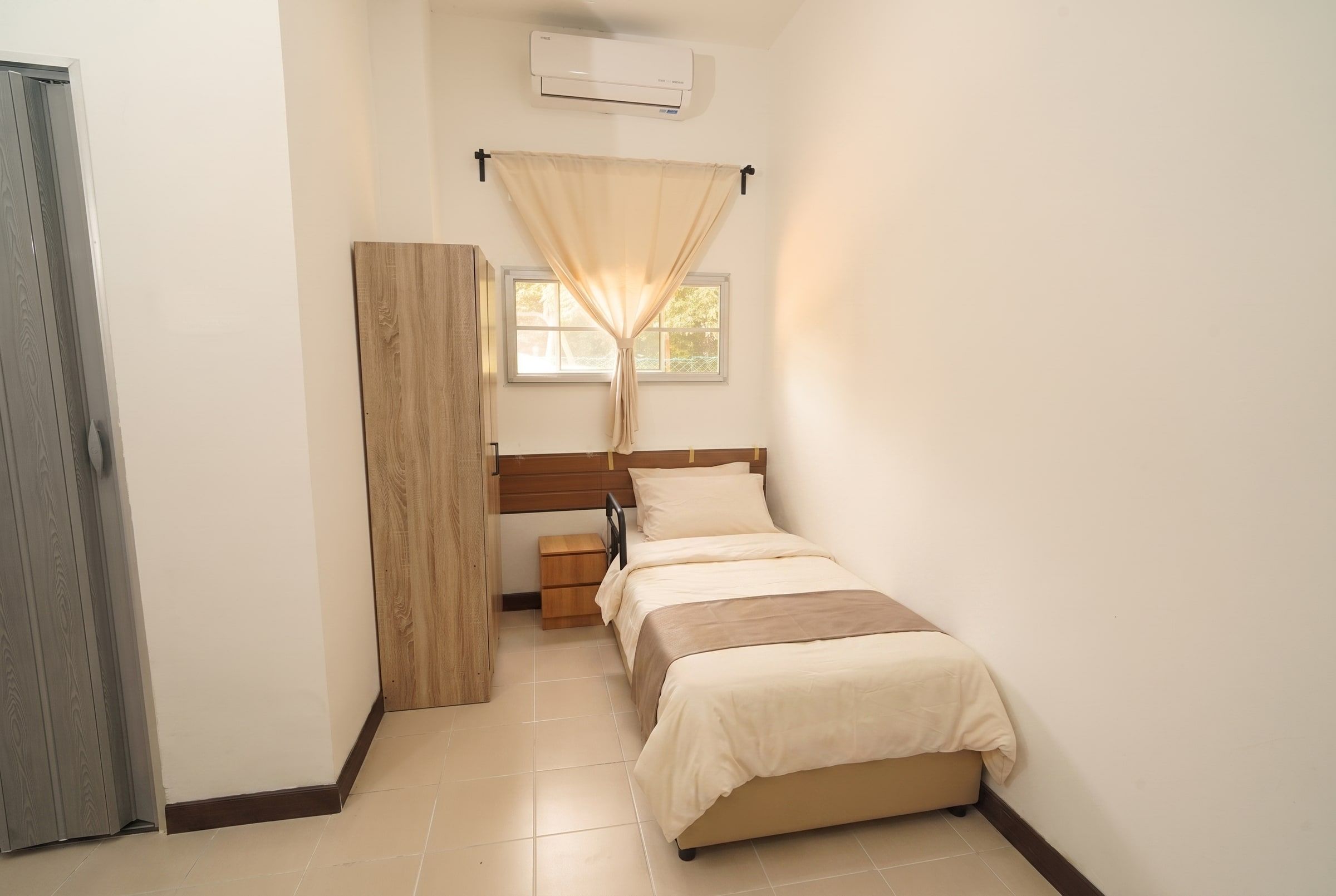 Calm resident bedroom with soft curtains and garden light
