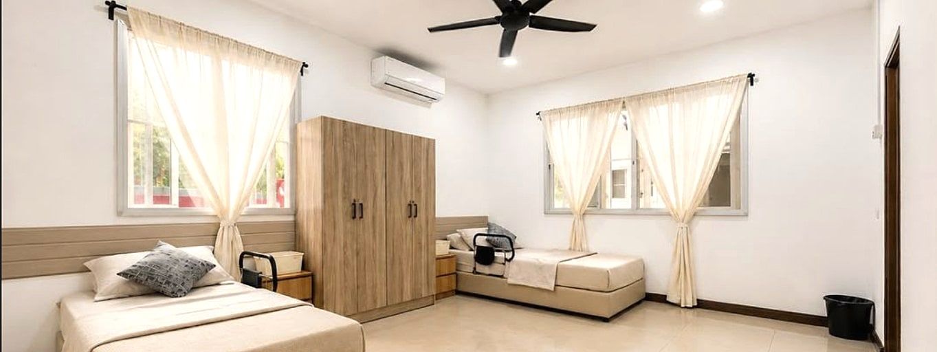 Twin Room — renovated room with two made-up beds and garden windows
