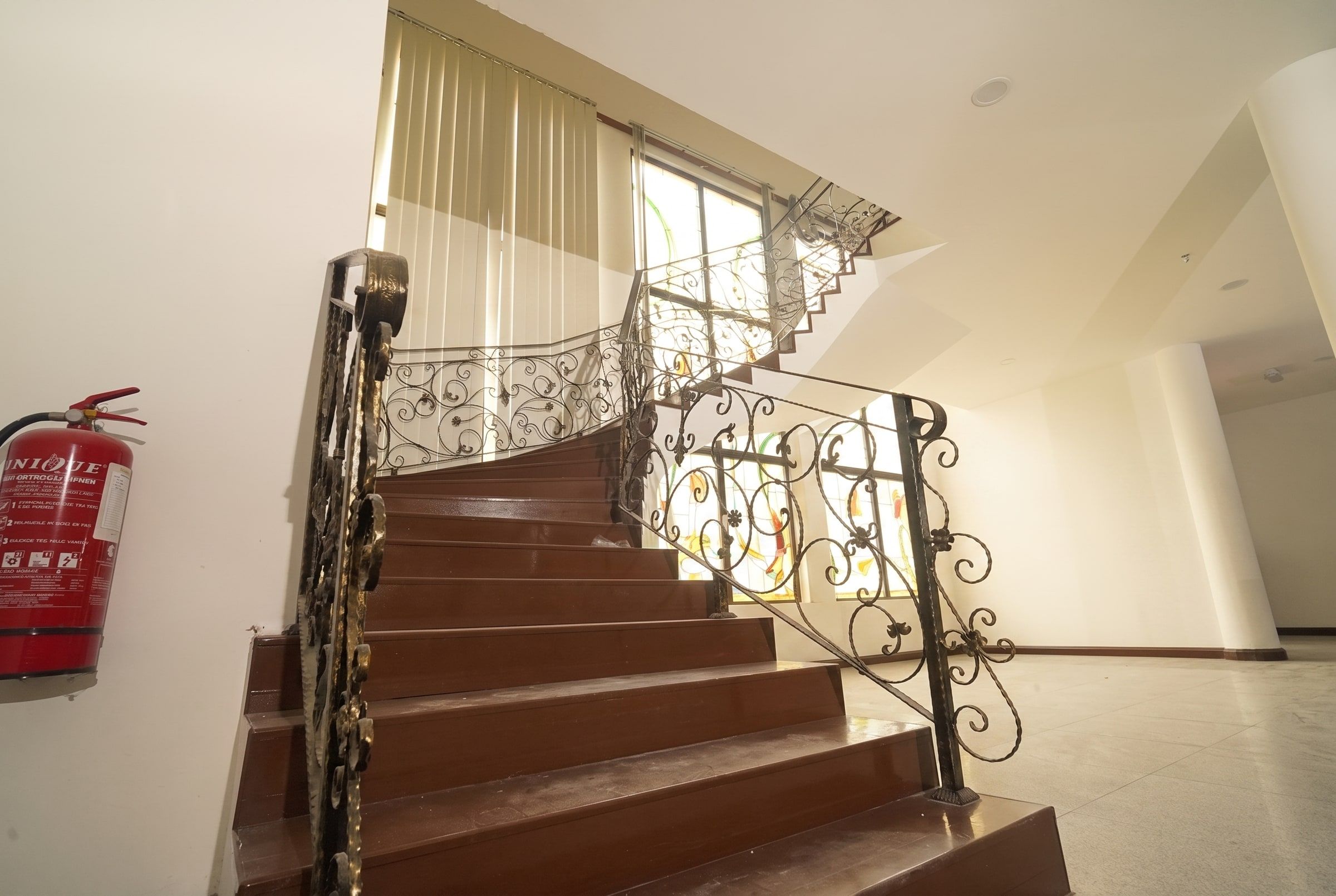 The residence's wrought-iron staircase seen from the foyer